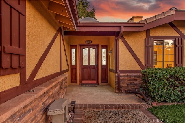 exterior entry at dusk with a porch