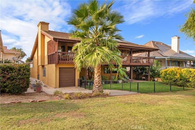 back of property featuring a lawn, a balcony, and a garage