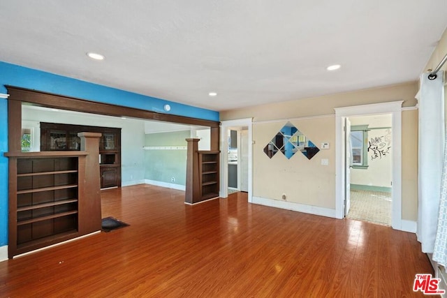 unfurnished living room featuring wood-type flooring