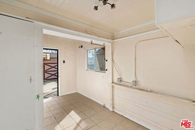 empty room featuring crown molding, light tile patterned floors, and wooden ceiling