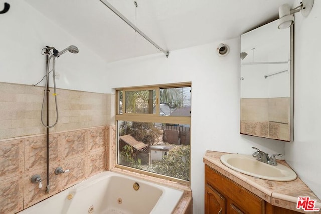 bathroom featuring a washtub and vanity