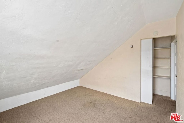 bonus room featuring carpet flooring and lofted ceiling