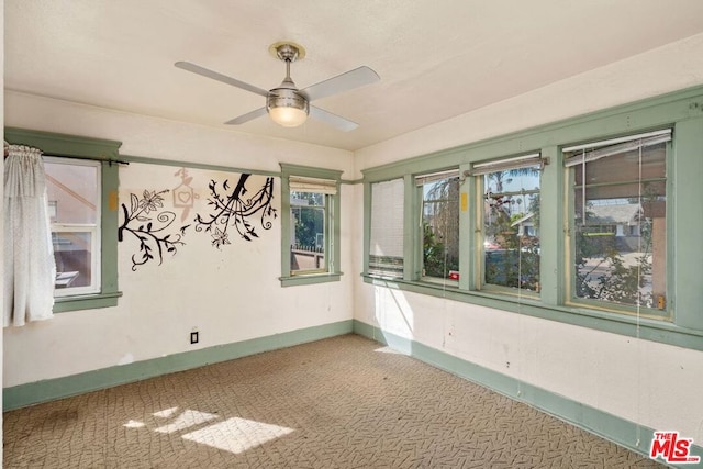 carpeted empty room featuring ceiling fan