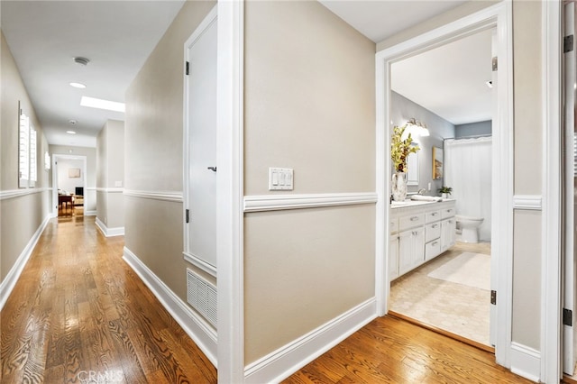 hallway with light wood-type flooring