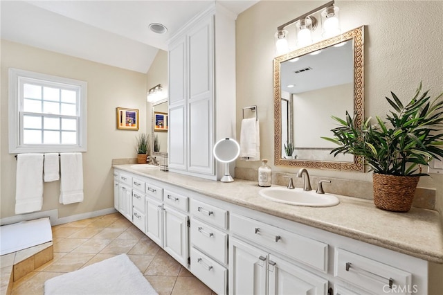 bathroom featuring vanity, lofted ceiling, and tile patterned floors