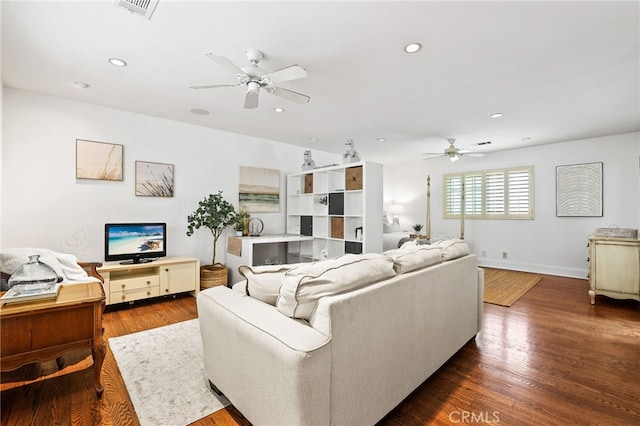 living room featuring hardwood / wood-style flooring and ceiling fan