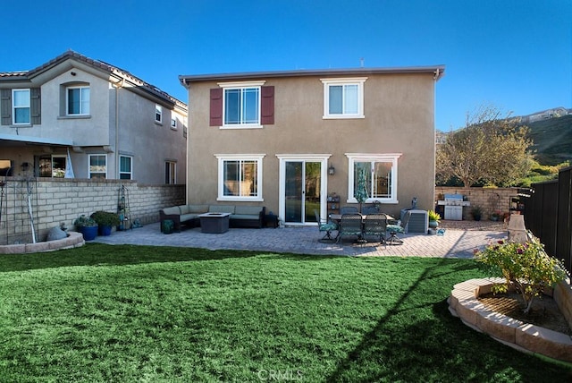 back of property with a patio, a lawn, and outdoor lounge area