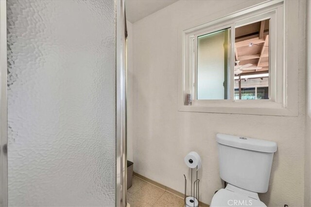 bathroom featuring toilet and a shower