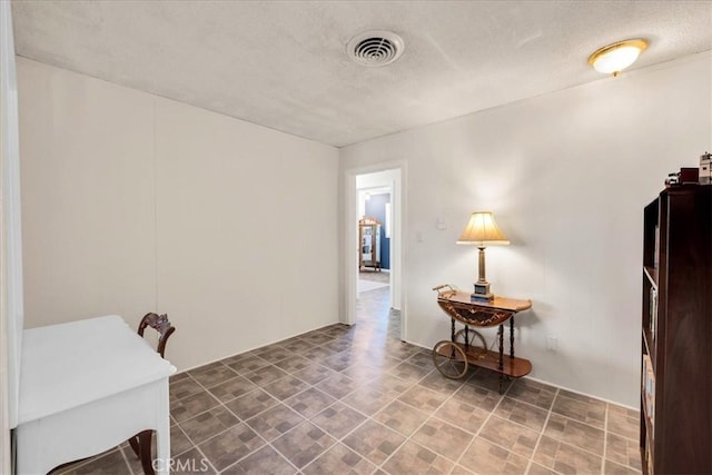 interior space with visible vents and a textured ceiling