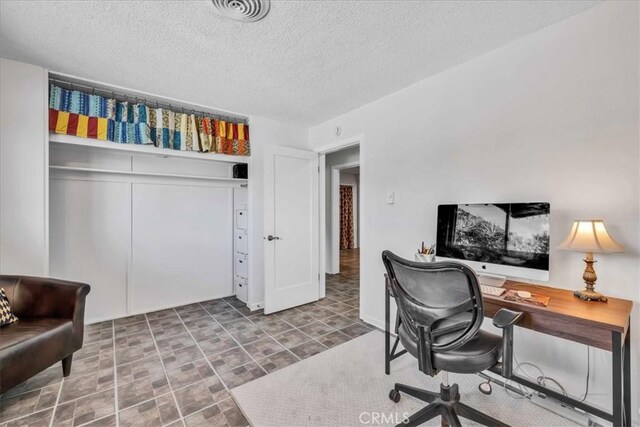 office with visible vents and a textured ceiling