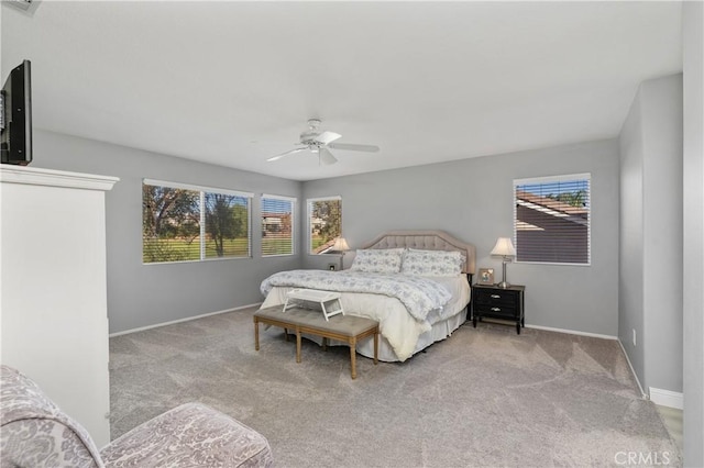 bedroom with ceiling fan and light carpet