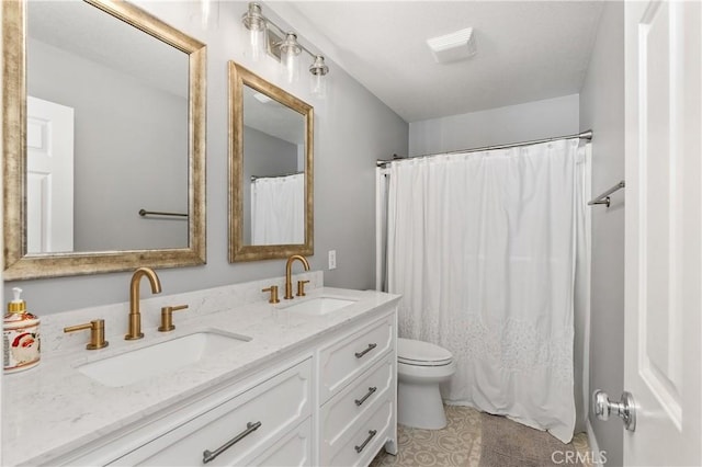 bathroom with a shower with shower curtain, tile patterned floors, vanity, and toilet