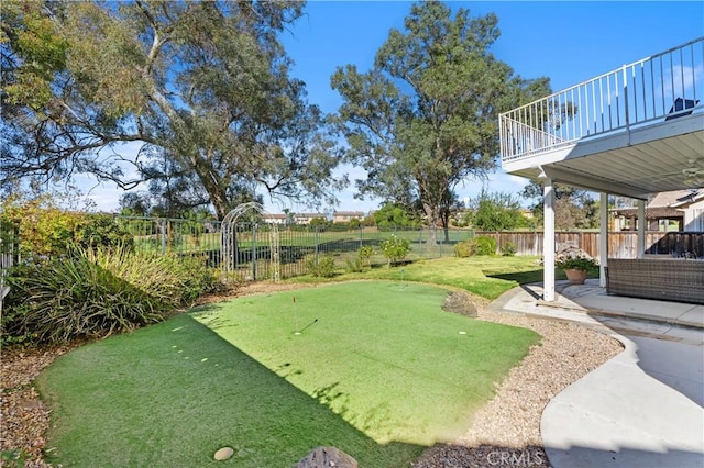 view of yard with a balcony and a patio