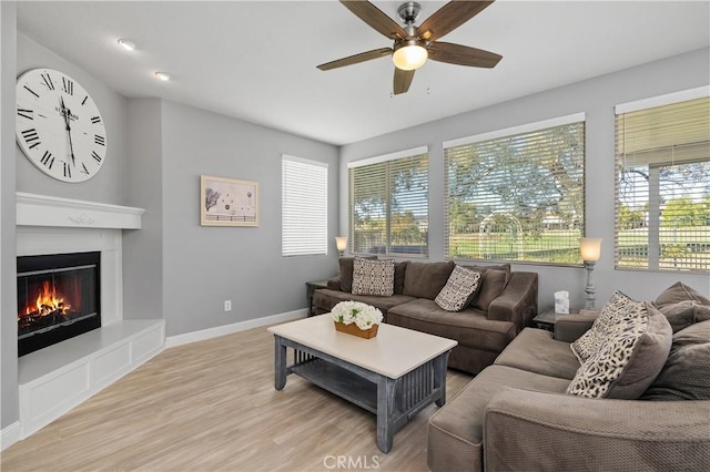 living room featuring light wood-type flooring and ceiling fan