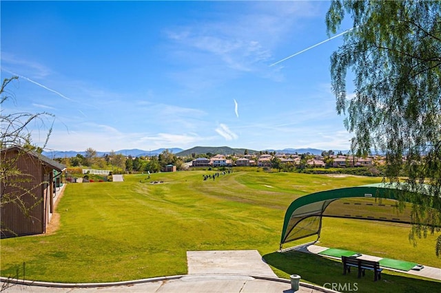 view of community featuring a mountain view and a lawn