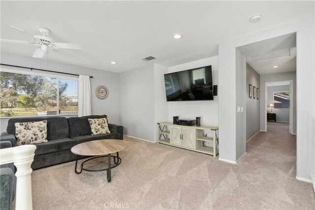 living room with ceiling fan and light carpet