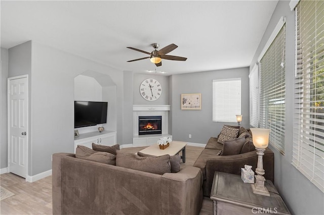 living room featuring light wood-type flooring and ceiling fan