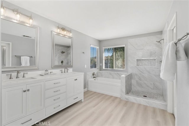 bathroom featuring separate shower and tub, wood-type flooring, and vanity