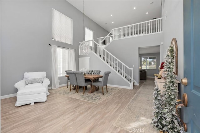 foyer featuring a towering ceiling and hardwood / wood-style flooring