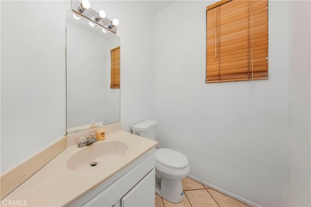 bathroom featuring toilet, tile patterned floors, and vanity