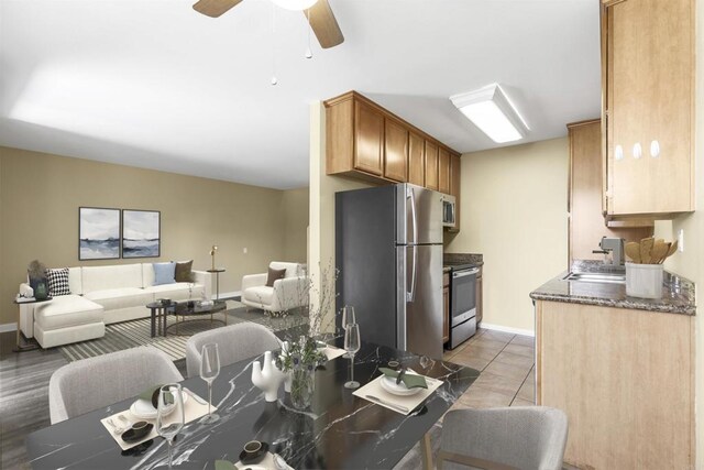 kitchen featuring sink, light tile patterned floors, ceiling fan, and appliances with stainless steel finishes