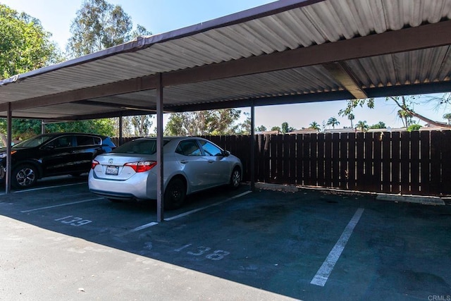 view of parking / parking lot featuring a carport