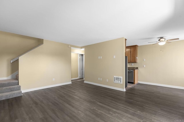 unfurnished living room with dark hardwood / wood-style flooring and ceiling fan