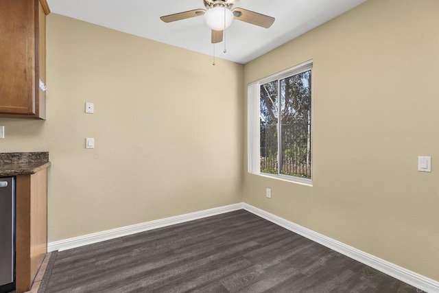 interior space with ceiling fan, dark wood-type flooring, and a healthy amount of sunlight