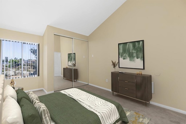 bedroom featuring high vaulted ceiling, a closet, and carpet