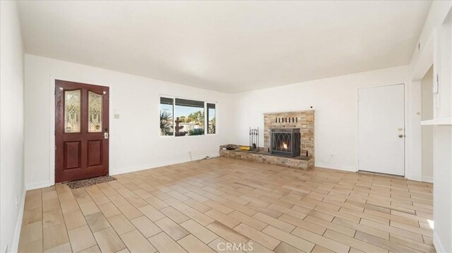 unfurnished living room featuring light hardwood / wood-style floors and a fireplace