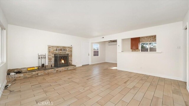 unfurnished living room featuring light hardwood / wood-style floors and a fireplace