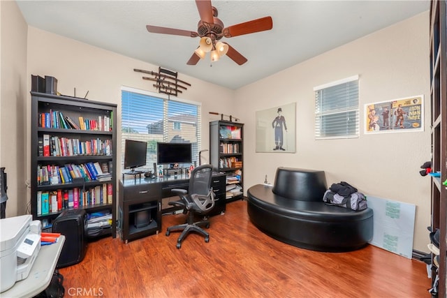 home office with ceiling fan and hardwood / wood-style floors