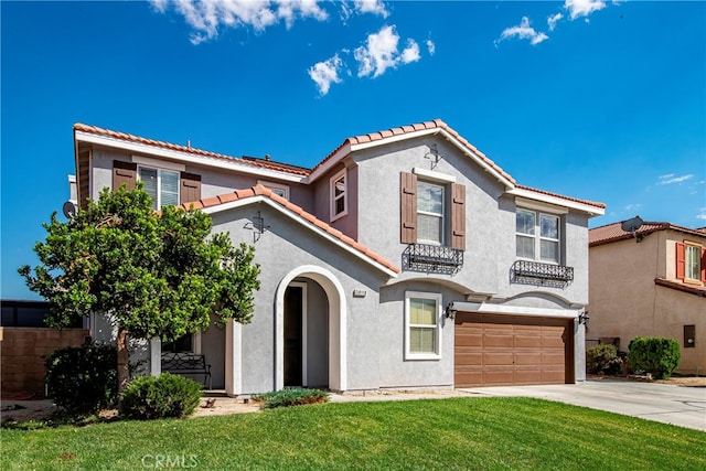 mediterranean / spanish house featuring a garage and a front yard