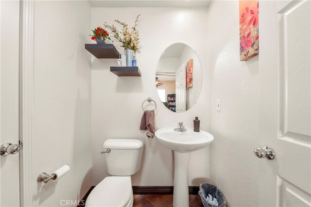 bathroom featuring sink, toilet, and tile patterned floors