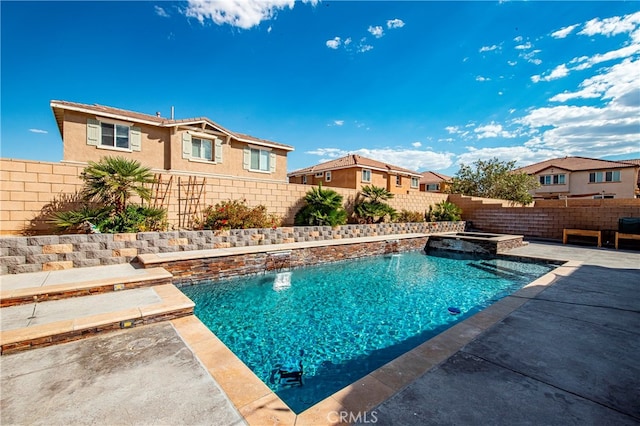 view of pool with an in ground hot tub, a patio area, and pool water feature