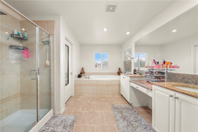 bathroom featuring independent shower and bath, vanity, and tile patterned floors