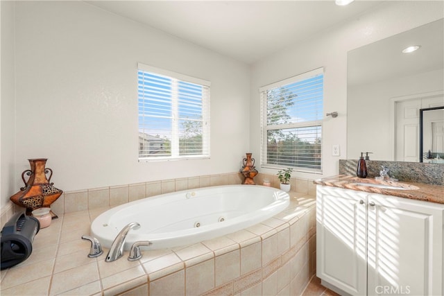 bathroom featuring a relaxing tiled tub and vanity