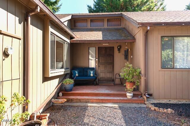 property entrance with a wooden deck