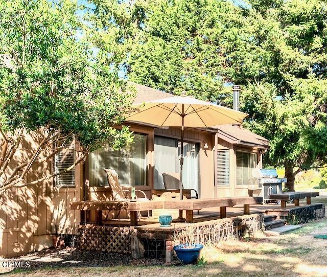 back of house featuring a wooden deck