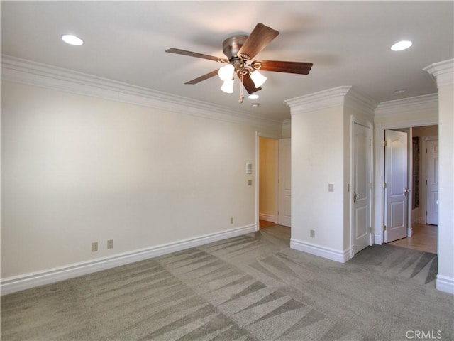 carpeted spare room featuring crown molding and ceiling fan