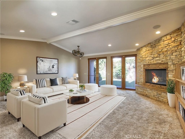 carpeted living room with french doors, vaulted ceiling with beams, a stone fireplace, a chandelier, and ornamental molding