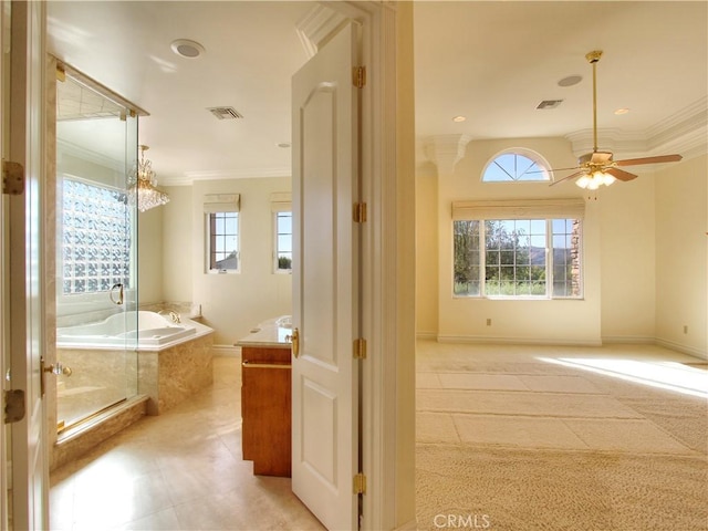 bathroom featuring ornamental molding, vanity, ceiling fan, and a healthy amount of sunlight