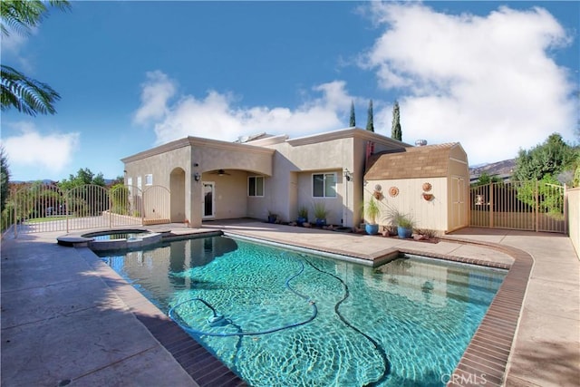 view of pool with an in ground hot tub, a patio, and ceiling fan