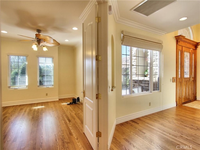 doorway to outside featuring ceiling fan, ornamental molding, and light wood-type flooring