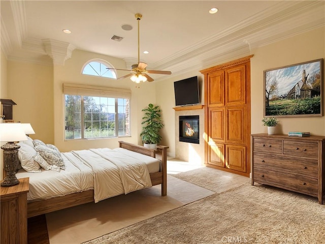 bedroom featuring ceiling fan, crown molding, and light carpet