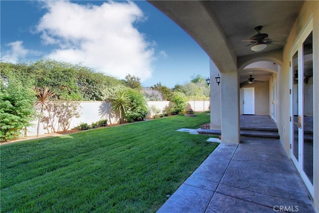 view of yard with a patio and ceiling fan