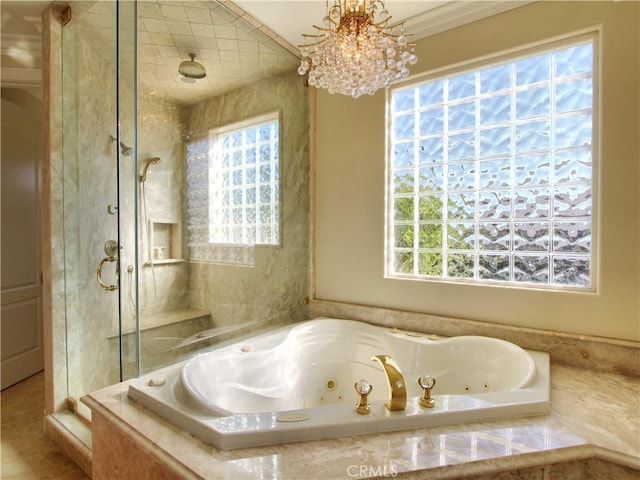 bathroom with a notable chandelier, crown molding, and independent shower and bath