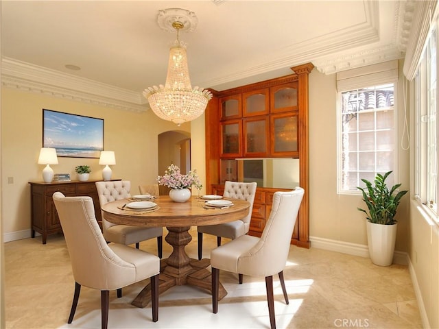 dining space featuring crown molding and an inviting chandelier