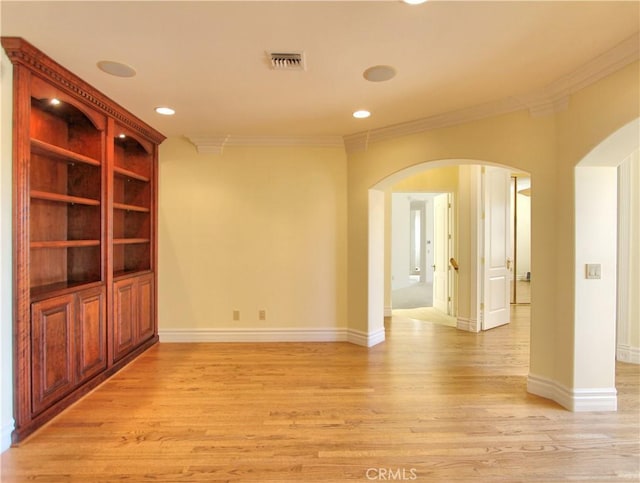 spare room with light hardwood / wood-style floors and ornamental molding