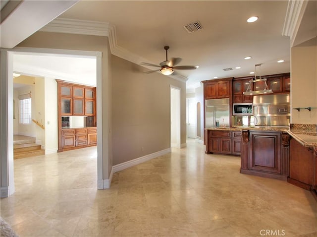 kitchen featuring appliances with stainless steel finishes, light stone counters, ornamental molding, ceiling fan, and decorative light fixtures